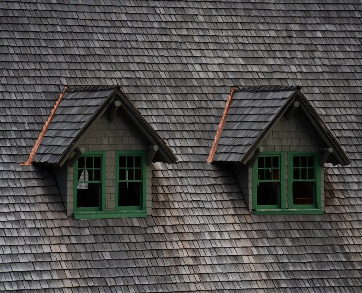 Dormers on a shingle roof in Reston, VA, where step flashing and kickout flashing carry water past the walls